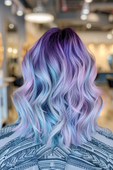 Wavy hair in shades of purple, blue, and pink in a salon setting. Blond Hair With Colored Tips, Blonde And Vivid Hair Color, Vivid Hair Color Ideas Blondes, Pastel Rainbow Hair Color, Pink Blue And Purple Hair, Purple Pastel Hair, Pastel Hair Dye, Pastel Hair Color Ideas, Rainbow Hair Color Ideas