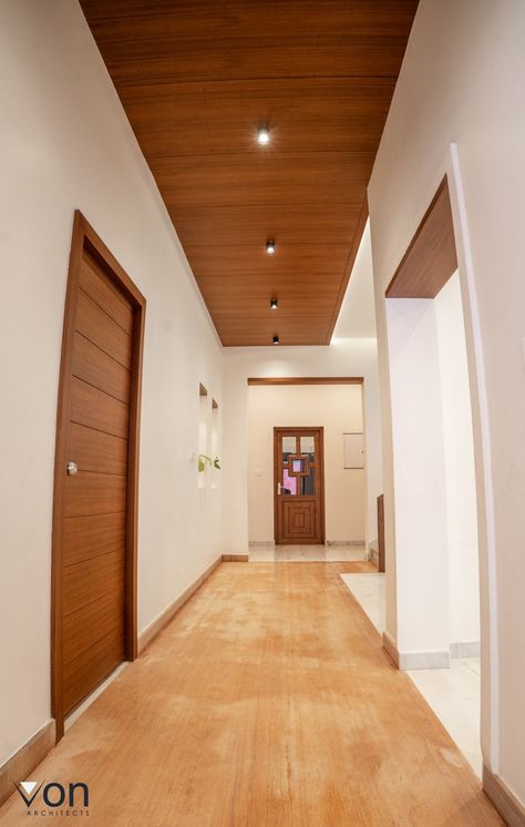 A stylish statment adorning the entryway beautifully commences the reveal of a well done home.Ceiling of the entrance is designed as a teak wood polish and floor also simulate in wooden touch. Entryway Ceiling Lights, Simple Home Interior, Hall Colour, Light Wooden Floor, Pvc Ceiling Design, Small Cottage House Plans, Wooden Ceiling, Pvc Ceiling, Wooden Ceilings