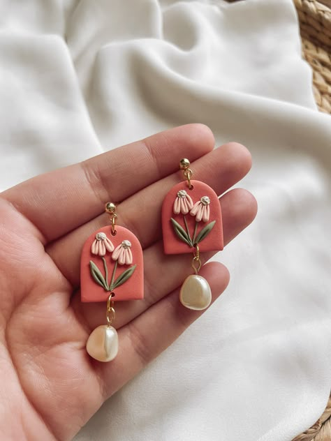 Achieve an elegant and sophisticated look with our "Promenade" Bridgerton-inspired floral clay earrings. Handmade with delicate floral details and pearls, these lightweight earrings add a simple statement to any outfit. Their soft colors make them the perfect accessory for a classic and timeless look. These earrings are made with gold-plated lightweight polymer clay and surgical stainless-steel posts (nickel-free). These earrings weigh less than 1oz and are approximately 1.2" in length. Polymer Clay Simple Earrings, Vintage Polymer Clay Earrings, Clay Earrings With Beads, Clay Statement Earrings, Clay Floral Earrings, Clay Earrings Diy Ideas Simple, Clay Earing Design, Diy Polymer Clay Earrings Ideas, Elegant Clay Earrings