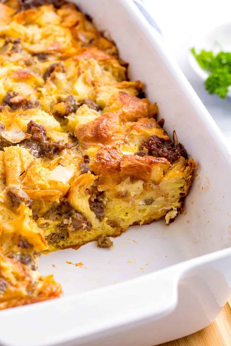 This easy sausage croissant breakfast casserole is the perfect make ahead meal. The flakey croissants, hearty sausages, and delicious cheese are a winning combination. Sausage Crossaint Casserole, Breakfast Casserole With Croissants And Sausage, Cheesy Sausage And Croissant Casserole, Croissant Roll Breakfast Recipes, Breakfast Crossiant Recipes, Overnight Crossaint Breakfast Casserole, Sausage Crossiant Bake, Egg Bake With Croissants, Sausage Egg Cheese Croissant Casserole