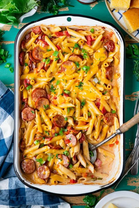 This zesty, flavorful dump-and-bake Cajun sausage pasta casserole comes together with just 10 minutes of prep. You don’t have to pre-cook the andouille sausage, sauté the veggies, or boil the noodles before everything goes into the oven! Cajun pasta with andouille sausage that’s easy, kid-friendly, and doesn’t require babysitting on the stovetop! What’s not to love?! The cozy casserole is a perfect example of a simple weeknight supper that brings the family together — even on busy evenings —... Denver Omlet, Sausage Pasta Casserole, Sausage Corn Dogs, Pasta With Andouille Sausage, Wedding Pasta, Cajun Pasta Sauce, No Boil Pasta, Sausage Noodles, One Pot Sausage