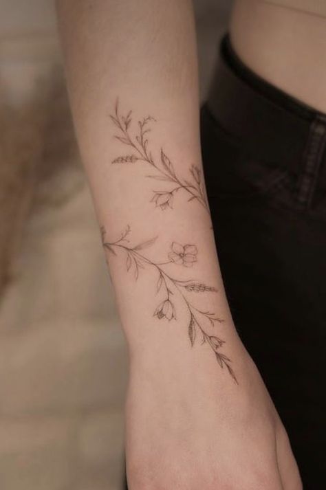 Dainty Flower Wrap Tattoo, Vines Wrapped Around Wrist Tattoo, Fine Line Floral Wrap Around Tattoo, Daffodil Vine Tattoo, Word Tattoo Behind Ear, Dog Tattoo Wrist, Fine Line Wrap Around Tattoo, Red Tattoo Hand, Vine Around Wrist Tattoo