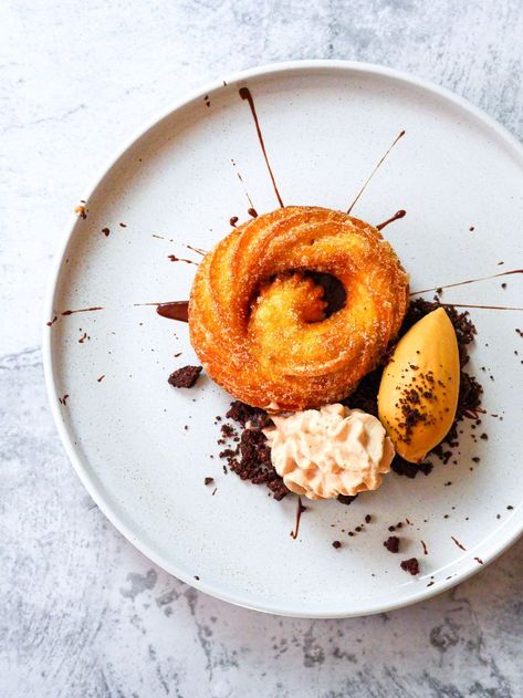 Churro Plated dessert There's just something about the crispy and doughy texture, the cinnamon sugar coating, and the way they're so perfect for dipping into chocolate that makes them irresistible. And now there's a new way to enjoy these delicious treats: as a plated dessert. Served with a “burnt” sugar ice cream, miso chocolate espuma, and a bitter chocolate sauce, it makes them even more irresistible. A super-easy plated dessert Dessert Recipes For Restaurants, Restaurant Plated Desserts, Simple Plated Desserts, Churros Presentation Ideas, Ice Cream Plated Dessert, Churros Plating Ideas, Easy Plated Desserts Ideas, Modern Dessert Plating, Easy Restaurant Desserts