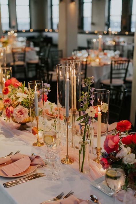 modern wedding colorful florals and candles | Image by Elvira Kalviste Long Table Decor For Wedding, Wedding Table Centerpieces Summer, Summer Wedding Ideas Indoor, August Wedding Decorations, Reception Wedding Decorations Indoor, Wedding Venue Decorations Indoor, Long Table Wedding Decor, Indoor Wedding Reception Decorations, Wedding Decorations Indoor