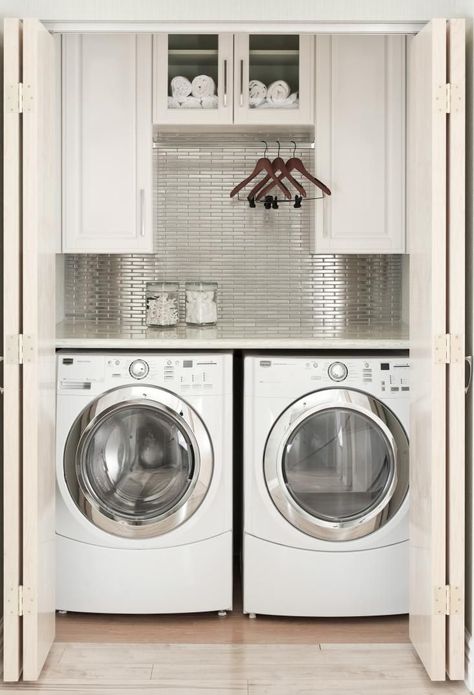 Laundry Room Closet Design Idea, Remodelista - this is about the same size as my laundry area but much more stylish! Laundry Room Ideas Closet Hanging Clothes, Laundry Room Ideas With Hanging Rod, Washer And Dryer Small Space Ideas, Hanging Rod In Laundry Room Cabinets, Laundry Closet Open Shelving, Laundry Room Upper Cabinets With Rod, Laundry Cabinet With Hanging Rod, Kitchens With Laundry Area, Laundry Room With Bar To Hang Clothes