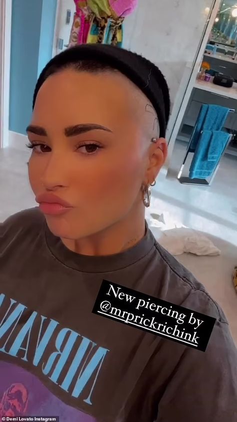 Demi Lovato shows new bar ear piercing after getting large black spider tattoo on side of their head | Daily Mail Online