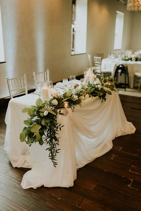 Wedding Sweetheart Table Garland, Flowers On Sweetheart Table, Sweetheart Table Wedding Decor Ideas, Bride And Groom Sweetheart Table Ideas, Sweetheart Table Greenery Garland, Couple Wedding Table Decor, Sweetheart Table With Garland, Garland On Sweetheart Table, Simple Bride Groom Table