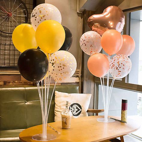 Two balloon stand kits with seven balloons each in different colors on a table in a coffee shop. Balloons On Sticks, Stick Centerpieces, Balloon Table Centerpieces, Balloon Stand, Balloon Holders, Balloons Decoration, Birthday Party Accessories, Diy Table Top, Balloon Stands