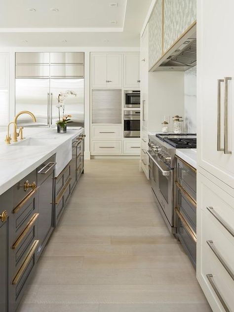 Stunning gray and ivory contemporary kitchen boasts a gray island outfitted with gray shaker cabinets accented with brass pulls and white marble countertops fitted with an apron sink and a brass gooseneck faucet. Gray Shaker Cabinets, Model Dapur, Two Tone Kitchen Cabinets, Серая Кухня, Kitchen Colour, Color Kitchen, Two Tone Kitchen, Colors Schemes, Countertops Kitchen