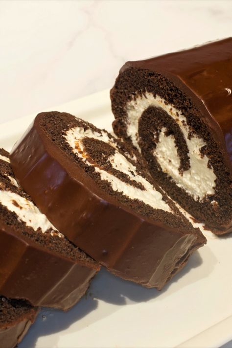 A sliced chocolate cake roll topped with chocolate ganache. Chocolate Cake Roll, My Country Table, Chocolate Swiss Roll, Chocolate Roll Cake, Bolo Red Velvet, Cake Roll Recipes, Dark Chocolate Cookies, Chocolate Cookie Dough, Chocolate Roll