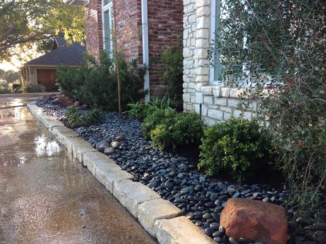 Here we used river rock instead of mulch. Makes for a dramatic look accented by boulders. Diy Rock Landscaping Ideas, Diy Rock Landscaping, Black Rock Landscaping, Black River Rock, Landscaping Grasses, Landscaping Garden Ideas, River Rock Garden, Front Landscape, River Rock Landscaping