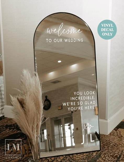 Transform your Large Arch Mirror into an Elegant Reception Mirror Sign using our Personalised Wedding Decals. Ideal as a wedding welcome decor, this decal warmly welcomes your guests while doubling as the perfect backdrop for unforgettable wedding selfies. Available in 8 romantic font styles, customise it with the couple's initials and your choice of phrases like "Welcome to Our Forever". 𝐖𝐇𝐘 𝐂𝐇𝐎𝐎𝐒𝐄 𝐎𝐔𝐑 𝐂𝐔𝐒𝐓𝐎𝐌 𝐖𝐄𝐃𝐃𝐈𝐍𝐆 𝐃𝐄𝐂𝐀𝐋𝐒? Ideal for the bride seeking to save mon Wedding Welcome Decor, Reception Mirror, Wedding Welcome Mirror, Large Arch Mirror, Reception Entry, Welcome Mirror, Mirror Wedding Signs, Wedding Decals, Wedding Entrance Sign