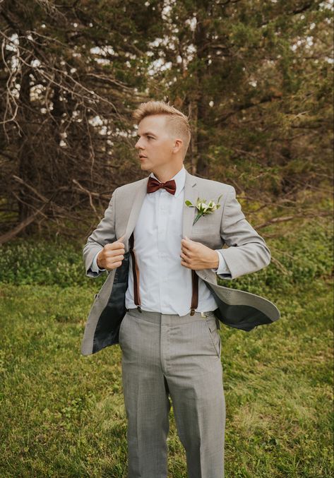 light grey suit with leather suspenders and rust accents Dark Grey Suit With Suspenders, Grey Suit Terracotta Tie, Groom Suit With Suspenders, Light Grey Suit Men, Suit With Suspenders, Brown Groomsmen, Grey Mens Suit, Plaid Suit Men, Grey Tux