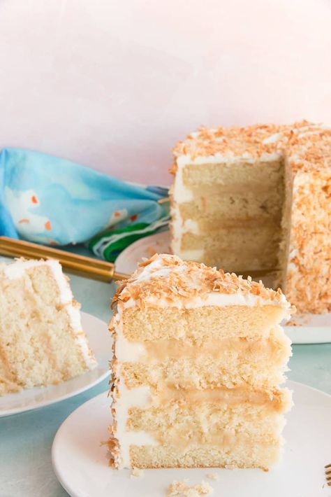 This Toasted Coconut Cake has layers upon layers of coconut flavor. A tender, moist coconut cake sandwiches creamy toasted coconut pastry cream and is wrapped in a coconut buttercream before being garnished with more toasted coconut flakes. Perfect for springtime celebrations. #cake #coconutcake #layeredcakes #cakerecipe #dessertrecipe #sweets #Easterdessert #springdessertrecipe #baking #cakedecorating #coconutcustard #coconutpudding #buttercreamfrosting #coconutfrosting #springbaking Toasted Coconut Cake Recipe, Coconut Pastry Cream, Toasted Coconut Cake, Moist Coconut Cake, Coconut Pastry, Best Coconut Cake Recipe, Coconut Layer Cake, Cake Sandwiches, Coconut Cakes