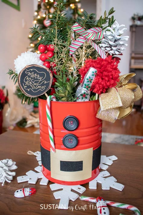 Make a statement with this sweet DIY Santa centerpiece using an upcycled coffee tin and plenty of holiday embellishments. Tin Can Santa Claus, Coffee Tins Upcycle, Coffee Can Christmas Crafts, Can Christmas Crafts, Tin Can Christmas Crafts, Tin Can Crafts Diy, Tin Can Christmas, Decorating With Driftwood, Unique Christmas Crafts