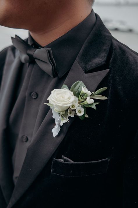 Black Suit Boutonniere, Wedding Flower For Groom, Ivory And Green Boutonniere, Green And White Wedding Boutonniere, All Black Suit With Sage Green Tie, Black Tux With Green Accent, Emerald Green Wedding Boutonniere, Groom Black Suit Sage Green Tie, Sage Green Boutonniere Groomsmen