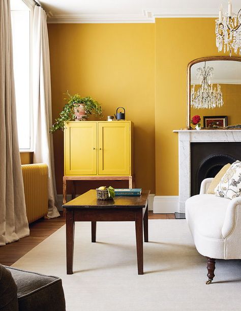 At Heckfield Place, the Ochre Room’s burnished yellow walls and ochre-painted cabinet and radiators create a cocooning effect. | Photographer: Courtesy of Heckfield Place Ochre Bedroom, Colour Drenching, Yellow Walls Living Room, Dark Green Living Room, Mustard Yellow Walls, Yellow Dining Room, Mustard Walls, Wallpaper Tropical, Yellow Room