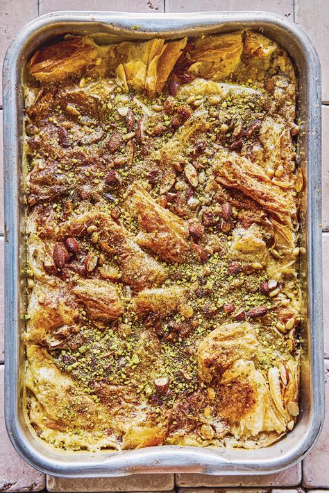 Similar to a bread pudding, this dessert is given a Middle Eastern twist with the addition of toasted nuts and rose water. We like golden raisins (available online and from many stores) for their juicy sweetness in my Om Ali. Darker raisins tend to be less juicy and more puckered, so use the same quantity of chopped dried apricots instead if golden raisins are hard to come by. If you use frozen puff pastry, thaw according to package directions before proceeding. Om Ali Recipe, Om Ali, Egyptian Bread, Cheddar Bread, Ramadan Recipes Iftar, Middle Eastern Sweets, Apple Cheddar, Moist Yellow Cakes, Raw Pistachios