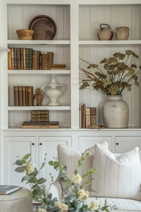 15 Bookshelf Decor Ideas That Will Make You Look Like a Styling Genius Bookshelf Styling Farmhouse, Fall Bookcase Decor Ideas, Modern Farmhouse Bookshelf Decor, Bookcase Styling Living Room, Farmhouse Fireplaces, Farmhouse Bookshelf Decor, Styling Built In Shelves, Bookshelf Decor Ideas, Bookshelf Decorating Ideas