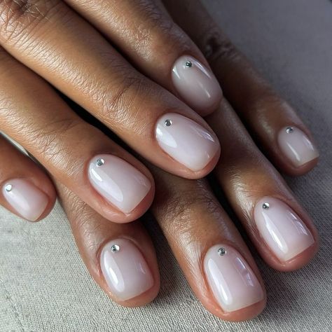 A milky bridal look by @polishedbylolo 🥛🫶🏾👰🏽💍 For this look she used Shield Fiber Base in #906 MILKY WHITE #kinetics #kineticsnails #weddingnails #bridalnails #weddinginspo #milkynails #perfectnails #buildergel #kineticnailsystems #milkynails #nudenails #minimalnails Neutral Japanese Nail Art, Milky White With Rhinestones, Milky White Nails With Jewels, Minimal Dot Nails, Creamy White Nails Design, Milky Shimmer Nails, Clear Polish Nail Designs, White Xmas Nails Short, Subtle Silver Nails