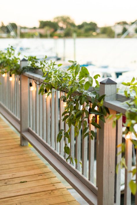 Deck Wedding Decorations Patio, Flower Railing Wedding, Outdoor Wedding Railing Decor, Deck Wedding Decorations, Wedding Deck Decorations, Greenery On Railing Wedding, Banister Decor Wedding, Smilax Greenery, Railing Wedding Decor