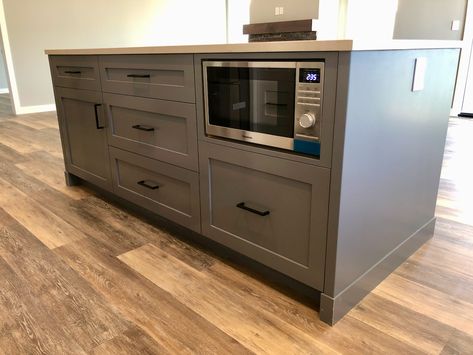 Another simple (but unique) feature of the 63 Mackenzie house is the microwave within the kitchen island. Benefits: 1) A microwave in a kitchen island can allow you to add an exhaust fan above your cooking stove. 2) You can save some space on counter tops or on top of islands if your microwave is inside the island. 3) It will ensure that your upper cabinet design looks sleek and has a sense of uniformity to it. Kitchen Island Microwave Shelf, Microwave In Counter Cabinet, Microwave Shelf In Island, Microwave Above Dishwasher, Appliances In Island, Kitchen Island With Stove And Microwave, Island With Built In Microwave, Microwave Island Cabinet, Kitchen With Microwave On Counter