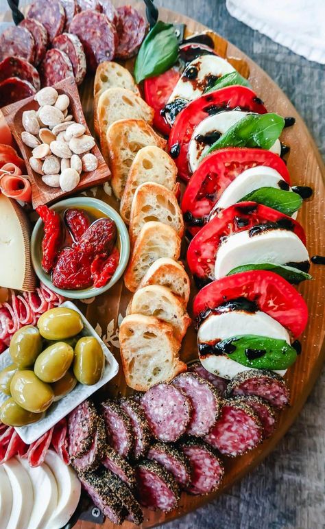 Italian Charcuterie Board. A beautiful Italian Charcuterie board filled with Italian meats and cheeses and paired with sauces, fruits, and vegetables. Perfect to pair with your Italian meal. #IndulgentDairy-BasedPastaDishes Italian Graze Board, Apple And Cheese Charcuterie Board, Italian Grazing Table Ideas, Italian Inspired Charcuterie Board, Italian Charturie Board, Charcuterie Board Pasta, Italian Charcuterie Board Antipasto Platter, Italian Board Ideas, Mediterranean Charcuterie Board Ideas