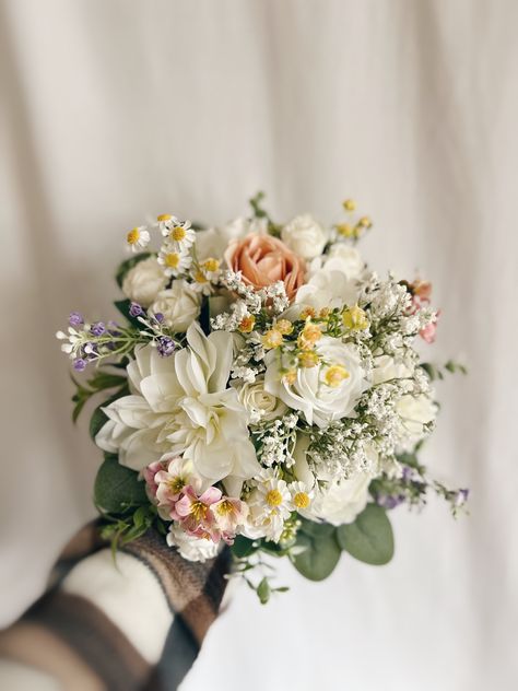 "These beautiful artificial wedding bouquets are made from faux flowers of white, off white and colorful flowers, sage greenery and silk eucalyptus. They will make the perfect addition to your big day!  This bridal bouquet consists of roses, peonies and dahlias with green silk eucalyptus and sage greenery and fillers. The stems are wrapped in twine. The bridal bouquet pictured is 12\" (30 cm). Bouquet Size Available: Bridal Bouquet- 12\" (30 cm) Bridesmaids Bouquet - 7\" (17 cm) Toss bouquet 6\" (15 cm) Matching bridesmaids bouquets, toss bouquet, corsages and boutonnières and other accessories are available." Wedding Bouquet Ivory Dress, Bridesmaid Flowers Simple Budget-bride.shop, Wildflower Bridesmaid Flowers, Flowers For A Sage Green Wedding, Simple Artificial Wedding Bouquet, Blush Bridesmaid Flowers, Simple Pastel Bouquet, Baby Breathes Flower Bouquet, Fern And Flower Bouquet