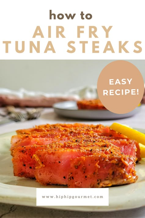 sliced seasoned tuna steak on a plate with a lemon, another in the background Ahi Tuna Steak Recipe Fully Cooked, Air Fry Ahi Tuna Steak, Tuna Steak In Oven, Frozen Tuna Steaks In Air Fryer, Fresh Tuna Steak Recipes Air Fryer, How To Prepare Tuna Steaks, How To Cook Tuna Steak In Air Fryer, Tuna Steak Air Fryer Recipes, Air Fried Tuna Steak