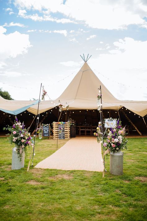 Tipi Reception Aisle Flowers Festoon Lights Lynsted Park Wedding Laura Debourde Photography #wedding #tipiwedding Tipi Marquee Wedding, Outside Wedding Entrance Ideas, Outdoor Marquee Wedding, Tipi Wedding Table Decoration, Festival Flowers, Marquee Wedding Decor, Wedding Tipi Decorations, Marquee Entrance, Tipi Wedding Flowers