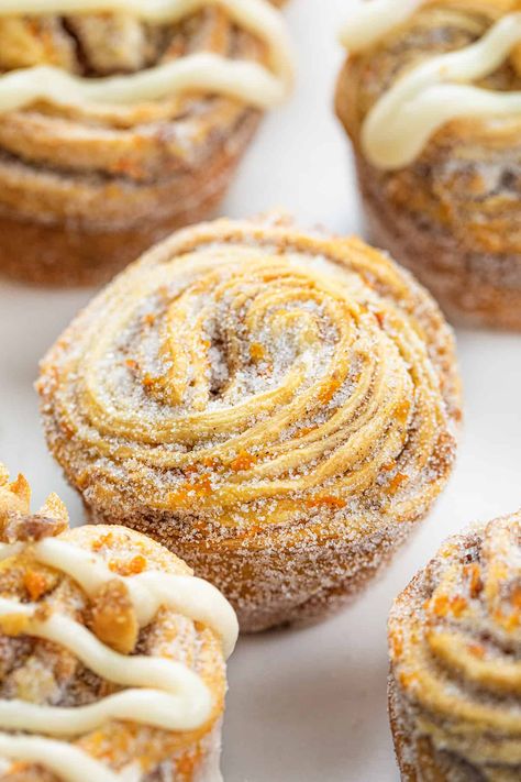 Absolutely delicious Carrot Cake Cruffins are crescent roll dough rolled up with all of the flavors of carrot cake, from the spices to the carrots to candied walnuts. The cruffins are rolled, cut, and baked in a muffin tin before being coated in more sugar and drizzled with a cream cheese glaze. It's the next best (and unique) way to enjoy all the flavors of a carrot cake! Carrot Cake Croissant, Unique Muffins, Unique Muffin Recipes, Cruffin Recipe, Doughnut Muffins, Mini Carrots, Carrot Cake Muffins, I Am Baker, Fruit Dessert Recipes