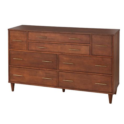 Need a little extra storage in your bedroom, but can't compromise when it comes to style? This dresser is here to help. It features eight drawers of various sizes that open on smooth ball bearing glides, so you can easily stow everything from T-shirts to slacks. This piece is crafted from a blend of solid and engineered wood with an oak finish, and showcases a streamlined silhouette with tapered dowel feet and slim, antique brass-finished bar pull handles. This dresser measures 34.3'' H x 56.9'' Dresser Oak, Recliner With Ottoman, Matching Nightstands, Bedroom 2024, Dresser Bed, 8 Drawer Dresser, Mid Century Modern Dresser, Hippie Look, Drawer Hardware