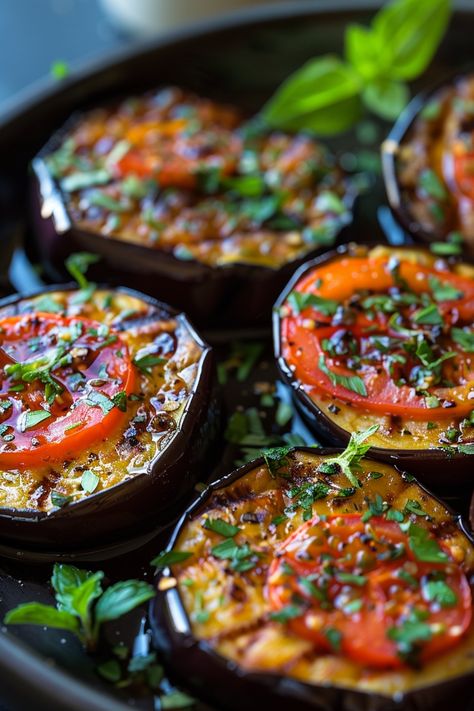 Slices of roasted eggplant topped with tomato slices and fresh herbs on a dark plate. Eggplant And Capsicum Recipes, Eggplant In Oil, Cooking Eggplant Best Way To, Globe Eggplant Recipe, Eggplant Recipes Healthy Baked, Eggplant Cottage Cheese Recipes, Delicious Eggplant Recipes, Round Eggplant Recipes, Eggplant Stacks Baked