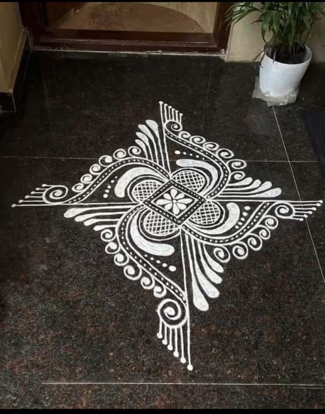 White Paint Rangoli Designs On Floor, Alpana Rangoli Design, Rangoli With Paints On Floor, White Paint Rangoli, Swastik Design Rangoli, Rangoli Designs With Paint, Painted Rangoli, White Rangoli Design Simple, Paint Rangoli Designs On Floor