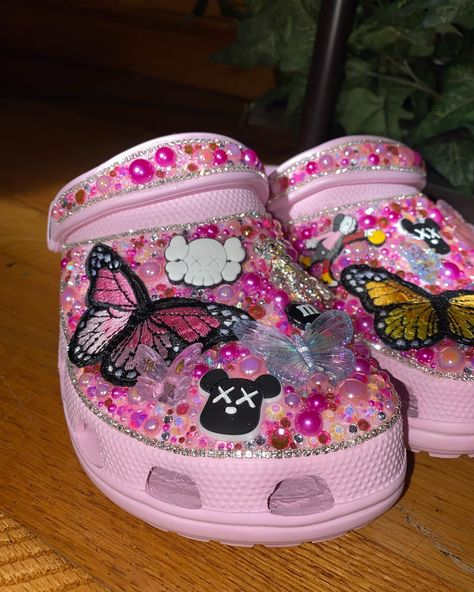 HAVE THESE ON HAND!! $135 ; Size 7W Pretty Pastel Pink💕 #crocs #explore Croc Decor Ideas, Decorated Crocs, Purple Shoes Outfit, Crock Ideas, Pastel Pink Butterfly, Croc Decor, Blinged Crocs, Designer Crocs, Taylor Swift Shoes