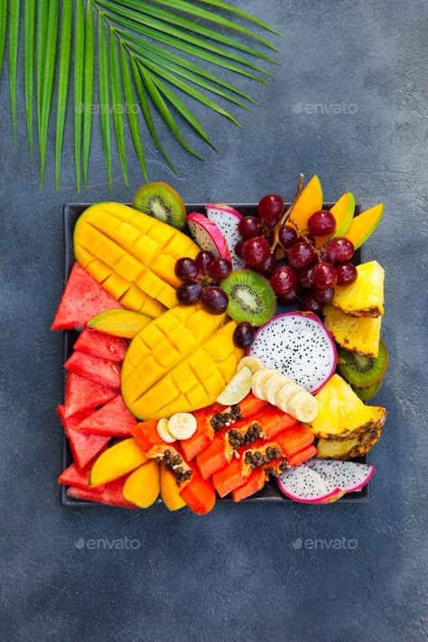 Tropical fruits assortment on a plate. Grey background. Top view. by annapustynnikova. Tropical fruits assortment on a plate. Grey background. Top view. #Sponsored #assortment, #plate, #Tropical, #fruits Fruit Presentation, Fruit Creations, Fruit Platter Designs, Fruit Platters, Tropical Food, Papaya Fruits, Fruit Decorations, Fruit Box, Fruit Carving