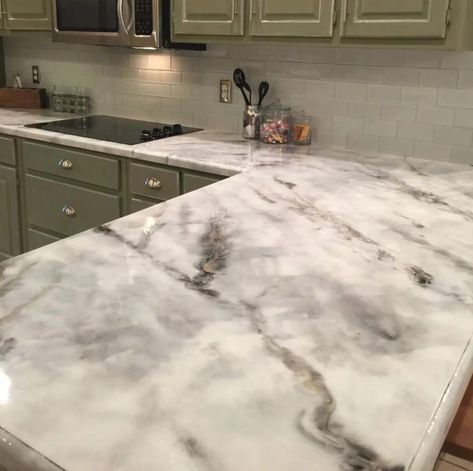 Marble is a gorgeous stone that exudes classical elegance, but it can cost a fortune. Marbleizing is a skillful technique you can use to create a faux marble finish that takes any piece to the next level. You can do marbleize a variety of surfaces, like ceramic tile, Formica countertops, kitchen cabinets, backsplash wood, linoleum, and more. To get a classic, chic, faux-Carrara marble effect in your own home or for your furniture refinishing project, follow this week’s Finish Friday video. In Faux Marble Countertop, Countertop Makeover, Bathroom Diy Ideas, Kitchen Diy Ideas, Epoxy Countertops, Replacing Kitchen Countertops, Kitchen Remodel Countertops, Diy Kitchen Countertops, Interior Design Blogs