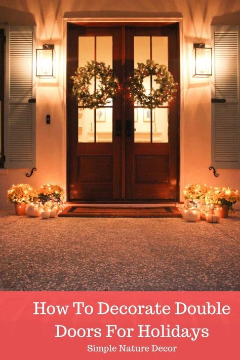 Decorate Your Double Front Doors For The Holiday. #wreathideas #frontdoors #holidaywreath Double Doors With Wreaths, Christmas Wreath For Double Front Door, Fall Decor Ideas For The Porch Front Double Doors, Wreaths On Double Doors, Double Front Door Fall Decor Ideas, Hanging Wreaths On Double Doors, Christmas Wreaths Double Doors, Christmas Wreaths For Double Front Door, Double Front Door Wreath Ideas