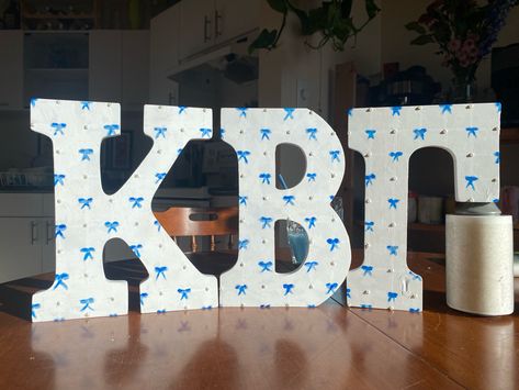 Cute hand painted bow letters for my little Sorority Letters Painted Ideas, Decorated Sorority Letters, Painted Sorority Letters, Wood Letter Painting Ideas, Greek Letters Painted, Sorority Letters Painted, Big Little Basket, Spring Recruitment, Alpha Gam