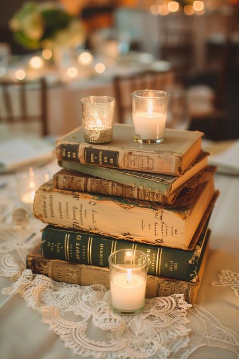 Transform your wedding tables into a storybook scene with our antique book centerpieces! 📚💒 Delicate lace runners and warm votive candles complete the romantic ambiance. Perfect for bibliophiles saying I do! #WeddingInspiration #VintageWedding #BookLover #RomanticDecor #WeddingIdeas #Candlelight #AntiqueChic #LaceDetails Let the love stories of old add charm to your special day! Wedding With Antiques, Book Themed Table Centerpieces, Vintage Book Wedding Centerpieces, Vintage Party Table Decor, Wedding Book Centerpieces, Vintage Gold Wedding Decor, Book Wedding Favors, Book Lover Wedding Ideas, Nonfloral Centerpiece Ideas