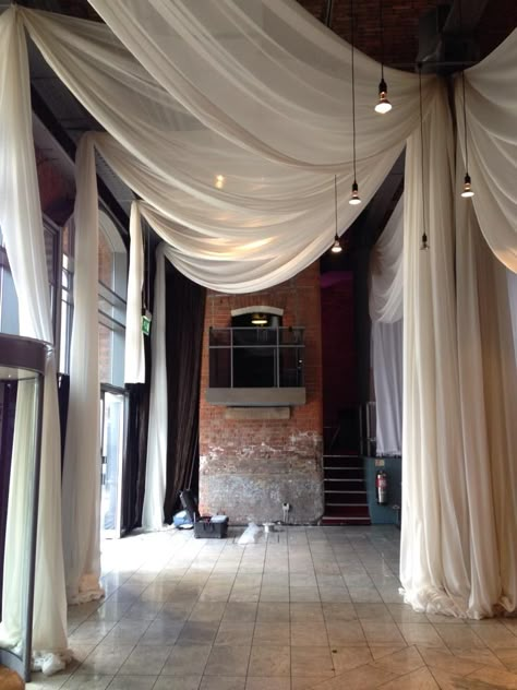 Venue Draping Image 7 Fabric Draped Walls, Cloth Ceiling Ideas, Fabric From Ceiling, Draping Fabric From Ceiling, Fabric Ceiling Ideas, Ceiling Fabric, Ceiling Drapery, Wedding Drapery, Wall Drapes