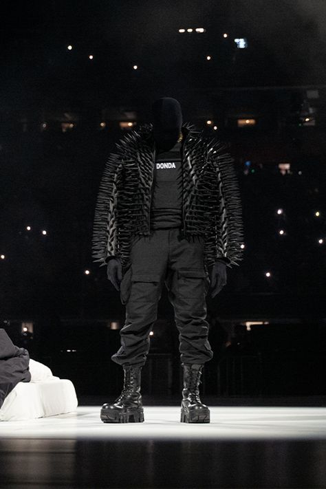 Kanye West in an all black outfit featuring a spike jacket from Balenciaga, vest with a ‘DONDA’ printed vest, cargos and boots. Minimal Swimwear, Kanye West Wallpaper, Kanye West Outfits, Chopped And Screwed, Balenciaga Black, All Black Outfit, Gaming Clothes, Studio Album, Hottest Trends