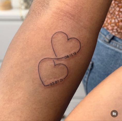 Fine line tattoos with connected hearts. Intertwined hearts with kids birth dates. Heart And Year Tattoo, Birth Year Heart Tattoo, Date Tattoo Ideas Behind Ear, Heart With Birthday Tattoo, 2 Dates Tattoo, Tattoos Dates Of Birth, Two Hearts Connected Tattoo, Tattoo Ideas Date Of Birth, Tattoo Dates Ideas