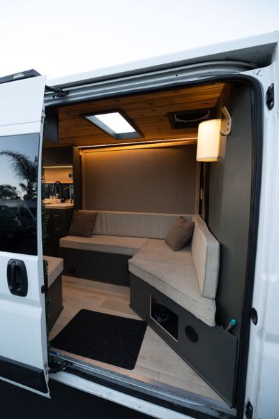 Camper Van For Sale: "Jazz" 2019 ProMaster Luxury Lounge on Wheels Projector In Van, Lwb Camper Conversion, Van Conversion Office, Pro Master Van Conversion, Sprinter Van Interior Ideas, Mobile Office Van, Camper Van Interior Ideas, Van Renovation, Sleeper Van