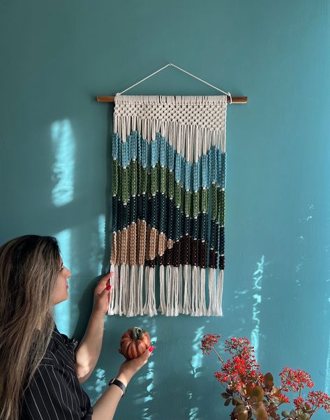 📏 Dimensions: 21.6"x 31.5 🌟 Materials: 100% Natural Cotton Cord, "Bamboo Wood Dowel 🎨 Colors: Lavender, Navy Blue, Soft Pink 🛍️ Includes: One Macrame Wall Hanging, A Macrame Keychain🌸  🌄 Embark on a visual journey with our Mountain Range Macrame Wall Hanging, a stunning handcrafted piece that captures the essence of a tranquil mountainous landscape. 🎨 Crafted with an artist's touch, this tapestry melds an array of soothing greens, blues, earthy browns, and creamy whites, creating a serene Rustic Chic Design, Yarn Tapestry, Wall Decor Macrame, Importance Of Art, Fiber Wall Hanging, Boho Macrame Wall Hanging, Mountainous Landscape, Handwoven Tapestry, Yarn Wall Art