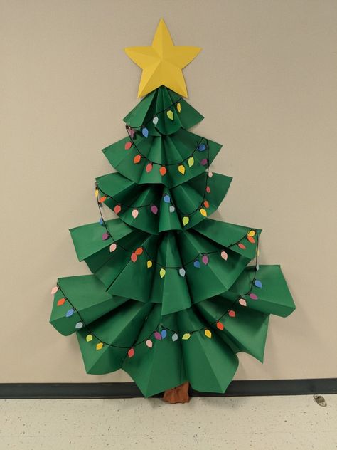 3-D Christmas tree bulletin board. Paper Tree Classroom Christmas, Diy Christmas Tree Classroom, Classroom Paper Christmas Tree, Christmas Tree Ideas For Classroom, Bulitin Board Ideas Christmas, Paper Christmas Tree Door Decoration, Paper Christmas Tree Bulletin Board, Christmas Tree For Classroom Door, Office Christmas Bulletin Board