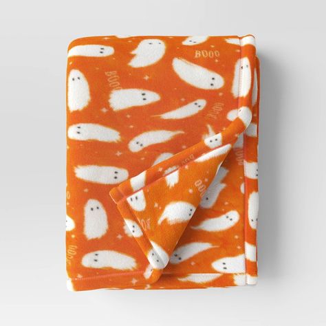 Snuggle up in fun and frightening style with this Ghost Printed Plush Halloween Throw Blanket from Hyde & EEK! Boutique™. This plush throw blanket features a white ghost and 'Booo' text pattern on a bright orange backdrop for a fun Halloween vibe. Made from soft and lightweight knit fabric, this blanket will keep you feeling cozy. Drape it over the back of your sofa or armchair to reach for while lounging, reading or watching TV. Hyde & EEK! Boutique™: Thrilling delights. Curious oddities. Fall Blanket Aesthetic, Halloween Throw Blanket, Streamer Party Decorations, Boo Basket Ideas, Fall Throw Blanket, Halloween Bedroom Decor, Boo Baskets, Halloween Bedroom, Fall Room