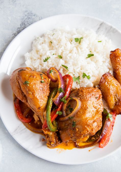 Dominican Braised Chicken or Pollo Guisado served on a plate with white rice, beans and maduros Guisado Recipe, Dominican Cooking, Dominicano Recipes, Meat Dish, Popular Dishes, Dominican Food, Braised Chicken, Recipe Chicken, Chicken And Rice