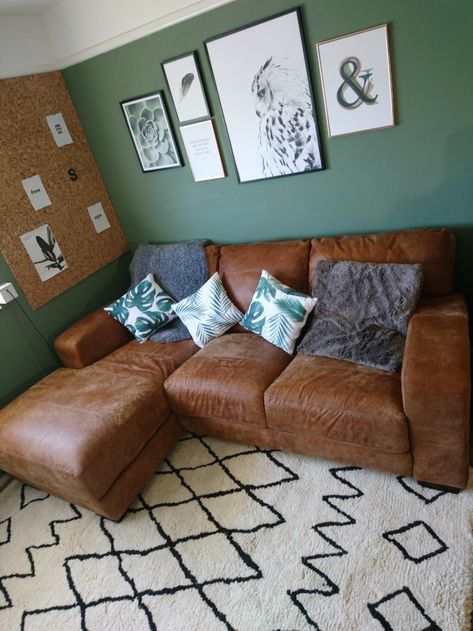 Our living room makeover features dark green living room decor. We painted the walls in Moss Blanket from Dulux and introduced a new leather sofa from DFS. The berber style rug is a cosy addition and the gallery wall features artwork from Desenio. Sage Green Living Room Dark Brown Sofa, Tan Leather Sofa Living Room Color Schemes, Dark Green Living Room Decor, Green And Brown Living Room, Moss Blanket, Teal Lounge, Living Room Sofa Modern, Green Walls Living Room, Couch Sets