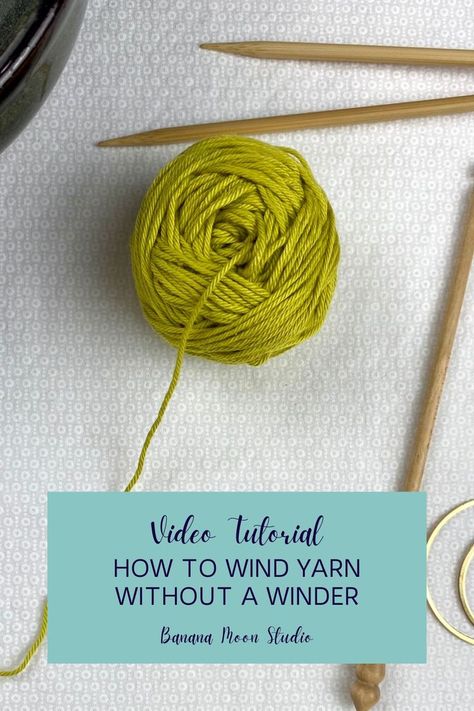 A small greenish yellow center-pull ball of yarn on a white background with knitting needles, a crochet hook, a yarn bowl, and a small brass crescent shape. An aqua panel with text reads: Video tutorial. How to wind yarn without a winder. Banana Moon Studio. Yarn Ball Winder Diy How To Make, Diy Yarn Ball Winder, Yarn Winder Diy, How To Wind A Center Pull Ball Of Yarn, How To Wind Yarn Into A Ball, Diy Yarn Winder, Crochet Tutorials Videos, Yarn Winders, Yarn Spinner